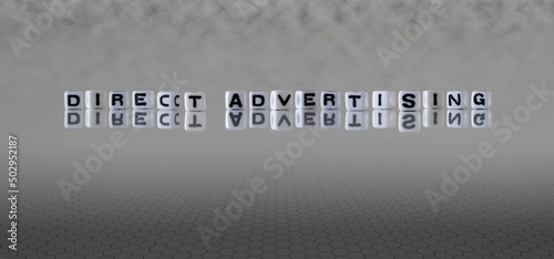 direct advertising word or concept represented by black and white letter cubes on a grey horizon background stretching to infinity