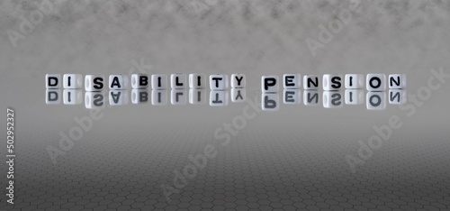 disability pension word or concept represented by black and white letter cubes on a grey horizon background stretching to infinity