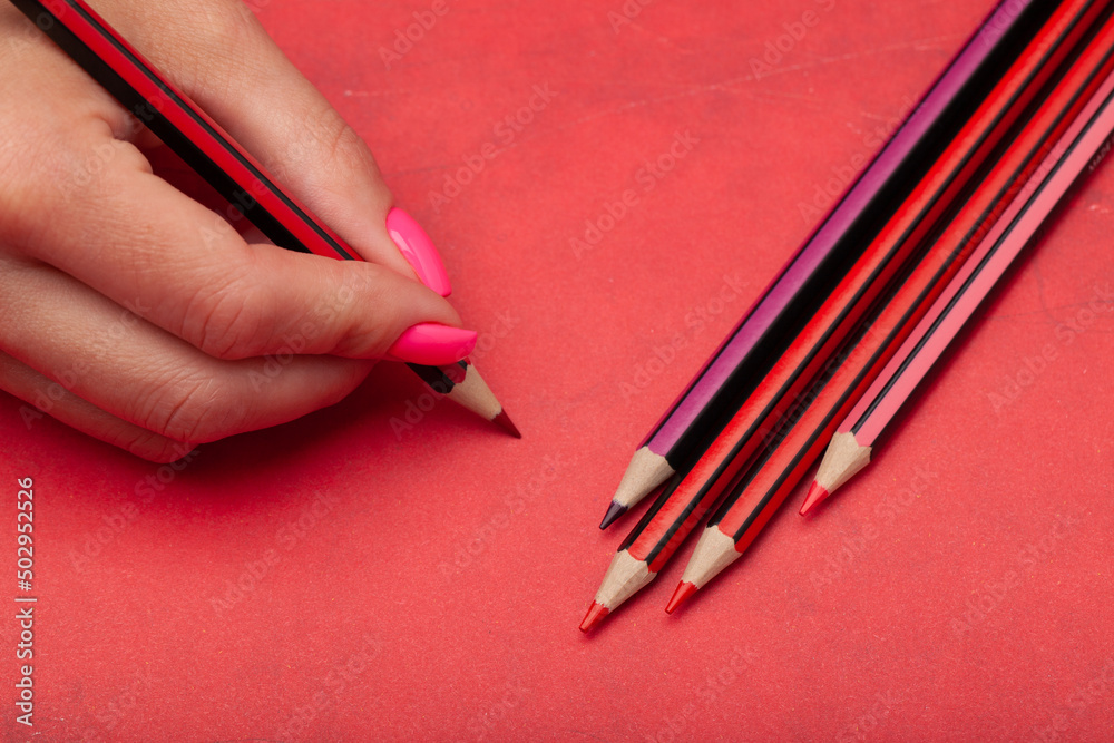 beautiful woman hands with color pencils