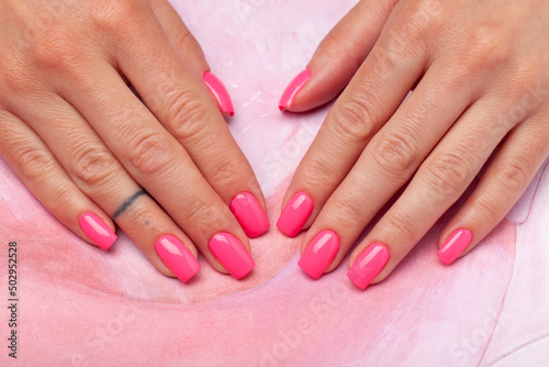 pink manicure on pink background