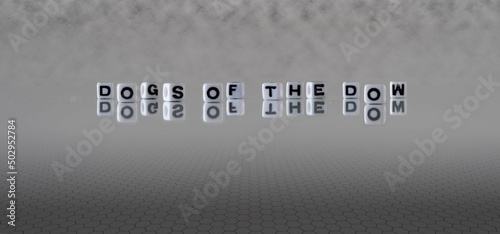 dogs of the dow word or concept represented by black and white letter cubes on a grey horizon background stretching to infinity