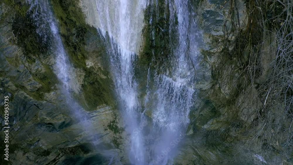 Water falling in deep gorge waterfall