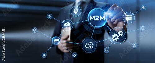 M2M Machine to machine industrial technology concept. Businessman pressing button.