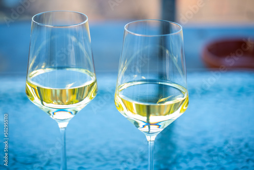 2 wine glasses on glass table, balcony photo