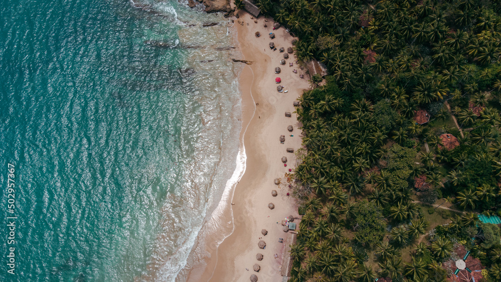 Tropical coast and ocean, drone shot, beautiful beach and water, tourist paradise.