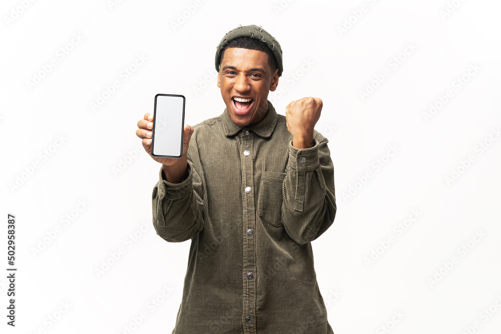 Happy satisfied man holding smartphone and smiling making yes gesture, celebrating online lottery or giveaway victory. Indoor studio shot isolated on white background Happy satisfied man holding smartphone and smiling making yes gesture, celebrating online lottery or giveaway victory. Indoor studio shot isolated on white background