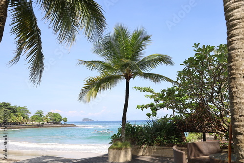 Amazing tropical paradise beach with white sand, coconut palm, sea and blue sky, outdoor travel background, summer holiday concept, natural wallpaper. 