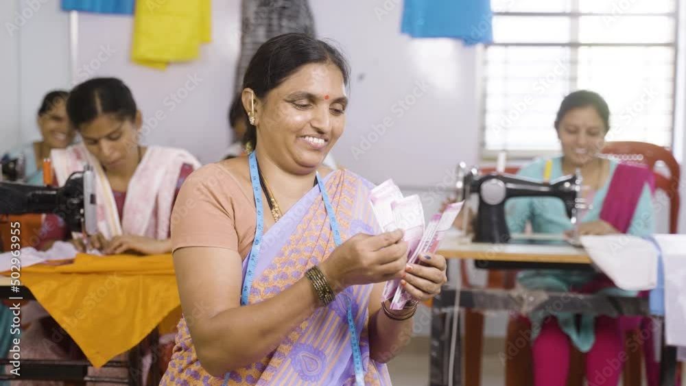 Happy smiling small business garments owner counting money at shop - conept of woman employment, earnings, financial and banking support Happy smiling small business garments owner counting money at shop - conept of woman employment, earnings, financial and banking support
