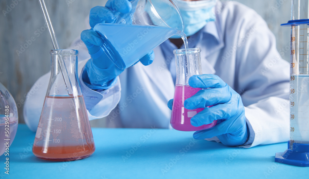 Girl working with flask in a laboratory. Girl working with flask in a laboratory.