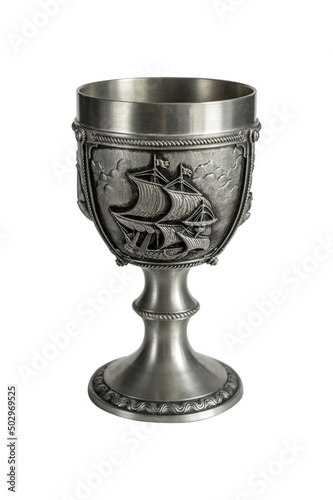 Pewter wine goblet with relief isolated on a white background. Photo with a shallow depth of field.