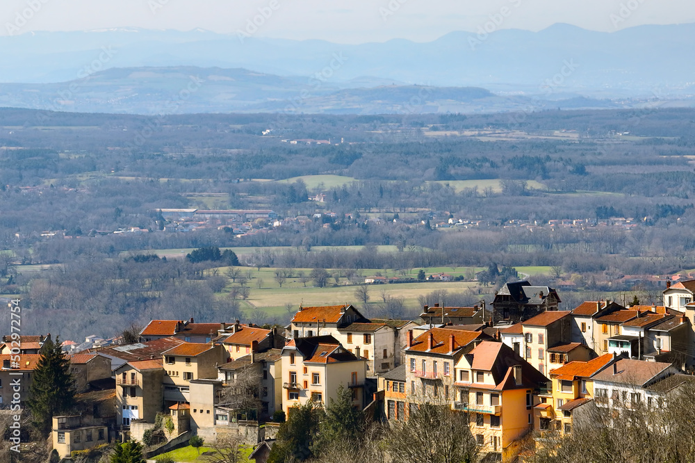 Fototapeta premium Aerial view of dense historic center of Thiers town in Puy-de-Dome department, Auvergne-Rhone-Alpes region in France. Rooftops of old buildings and narrow streets