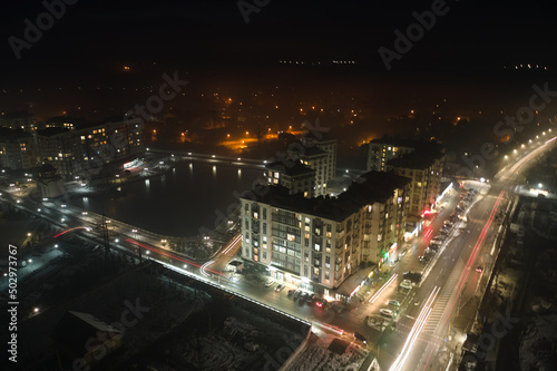 Wallpaper Mural Aerial view of high rise apartment buildings and bright illuminated streets in city residential area at night. Dark urban landscape Torontodigital.ca