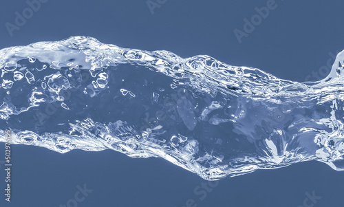 Water splash on a blue background. Reflection on the surface of the water.