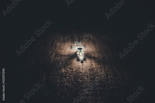 tractor works the land at night, view from a drone