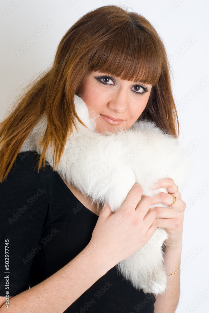 Young pretty woman wearing white fur over white Young pretty woman wearing white fur over white