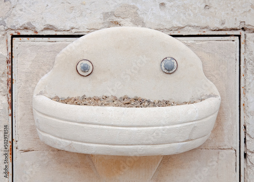 Some people will see a funny smiling face in what it's a stone fountain or a cigarette container. This phenomenon is called pareidolia.
 photo