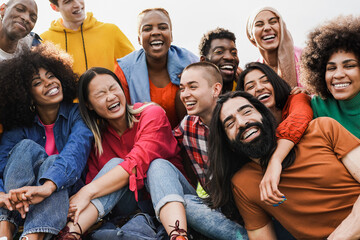 Group of multiracial people enjoy day at city park - Diverse young friedns having fun outdoor
