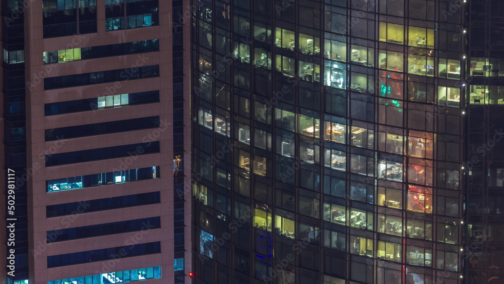 Windows in high-rise building exterior in the late evening with interior lights on timelapse Windows in high-rise building exterior in the late evening with interior lights on timelapse