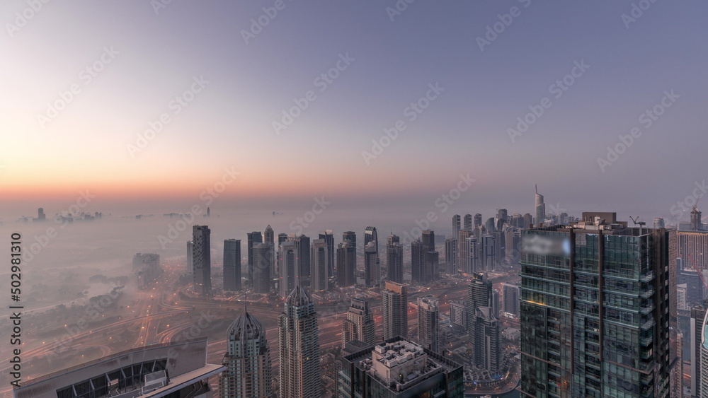 Obraz premium Panorama of Dubai Marina with JLT skyscrapers and golf course night to day timelapse, Dubai, United Arab Emirates.