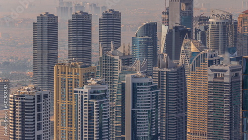 JLT skyscrapers near Sheikh Zayed Road aerial timelapse. Residential buildings and villas behind © neiezhmakov