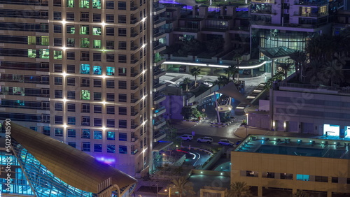 Exit from metro station and traffic on a road in Dubai marina night timelapse