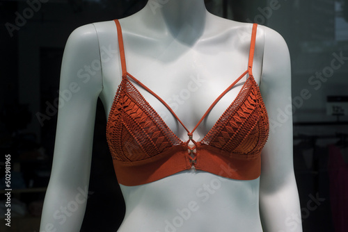 Closeup of orange Bra on mannequin in a fashion store showroom