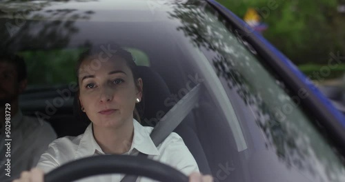 Young woman driver in Uber driving a client