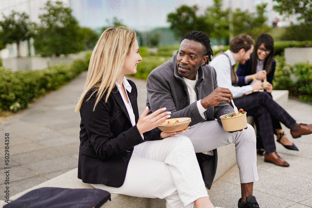 Fototapeta premium Multiracial business people eating healthy meal outdoor