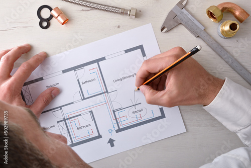 Technician reviewing the design of a home water installation