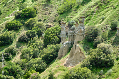 Kuladocia rock formation, fairy chimney and rock hoodoo, natural geological formation in Manisa Kula Turkey during spring time and green grass.