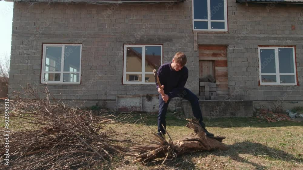 Man cutting a log outdoors Man cutting a log outdoors