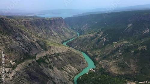 Sulak canyon - the deepest canyon in Europe on a sunny summer day. The turquoise waters of the Sulak River flow through the gorge. Tourist attraction. The Republic of Dagestan. Drone view. photo