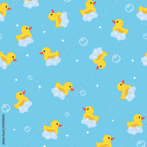 Іeamless pattern. Yellow rubber ducks with foam on a blue background. children's background