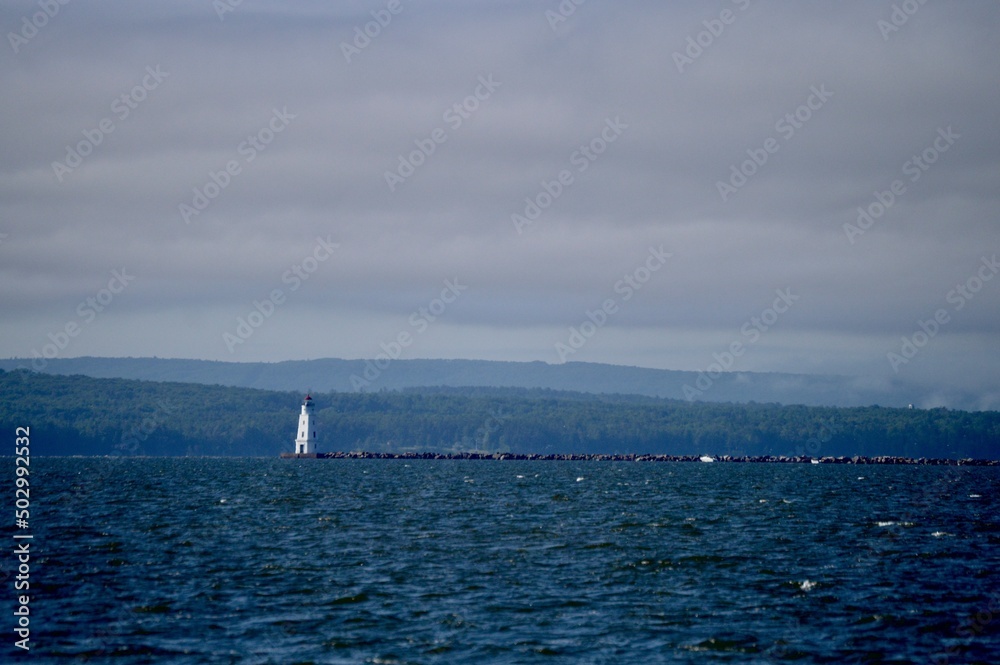 Obraz premium Moody restful Lake Superior near Ashland Wisconsin with a lighthouse and water break in the distance.