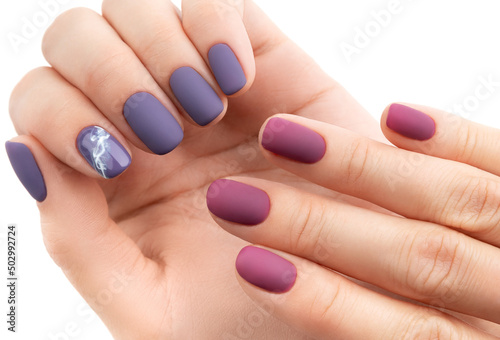 Beautiful purple burgundy matte manicure on white background.