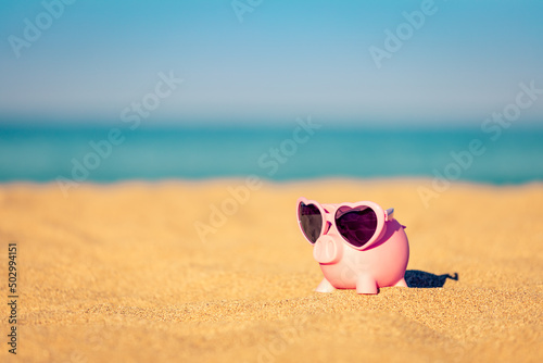 Sticker Piggybank on the beach in summer