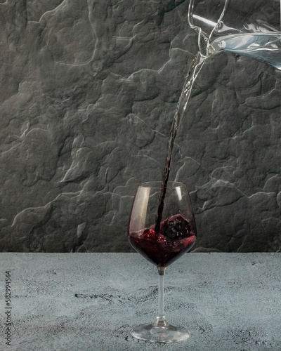 pitcher pouring water that changes to wine half way down the pour and into the wine glass