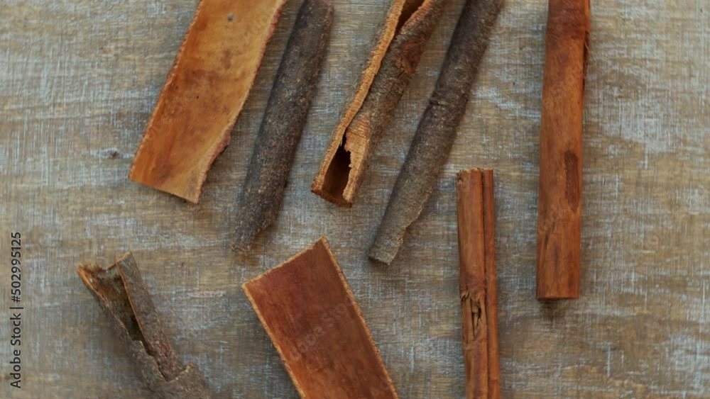 Dalchini cinnamon sticks (Cinnamomum cassia) spice on a table. Top view, table rotate. Dalchini cinnamon sticks (Cinnamomum cassia) spice on a table. Top view, table rotate.