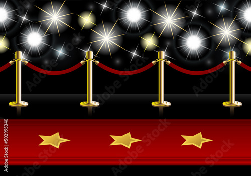 Red Carpet with poles and barrier rope in front of flash lights