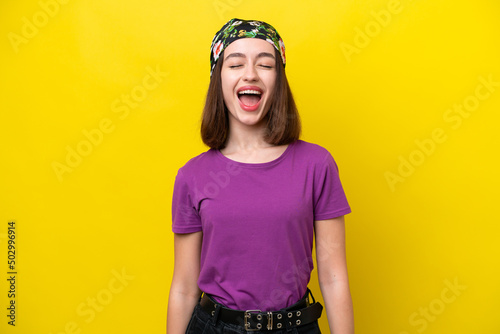 Young Ukrainian woman isolated on yellow background shouting to the front with mouth wide open