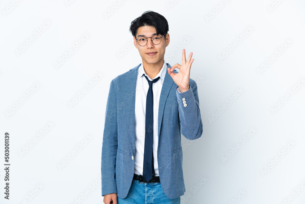 Young Chinese business man isolated on white background showing ok sign with fingers Young Chinese business man isolated on white background showing ok sign with fingers