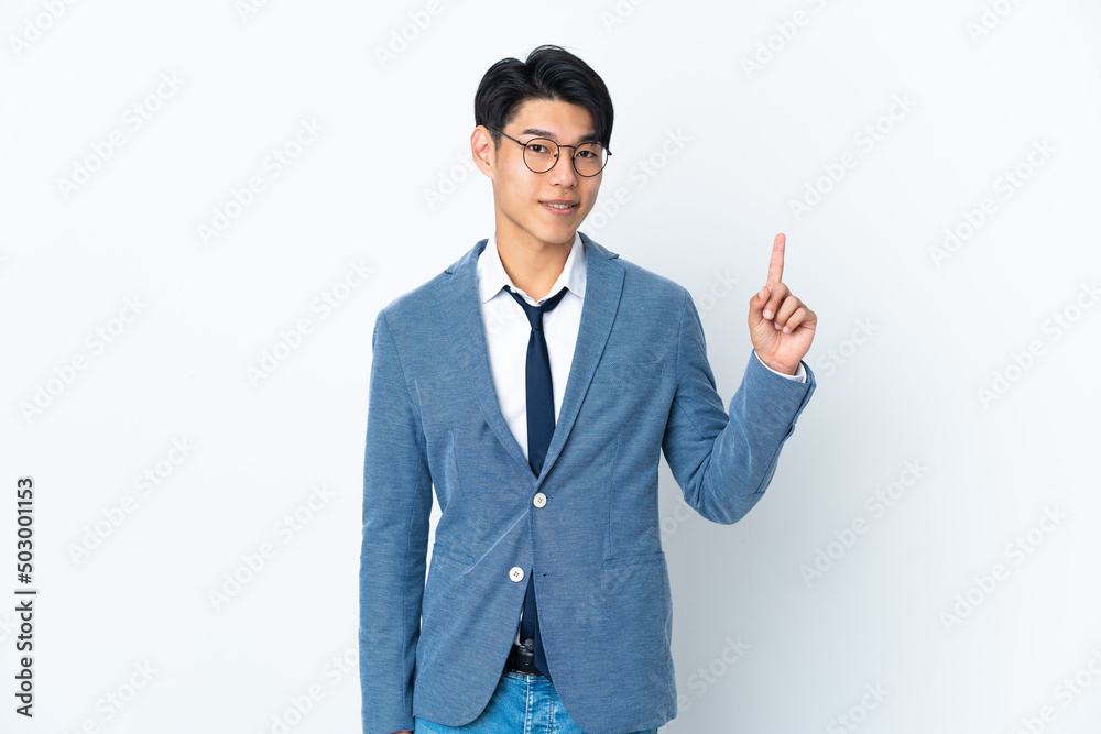 Young Chinese business man isolated on white background showing and lifting a finger in sign of the best Young Chinese business man isolated on white background showing and lifting a finger in sign of the best
