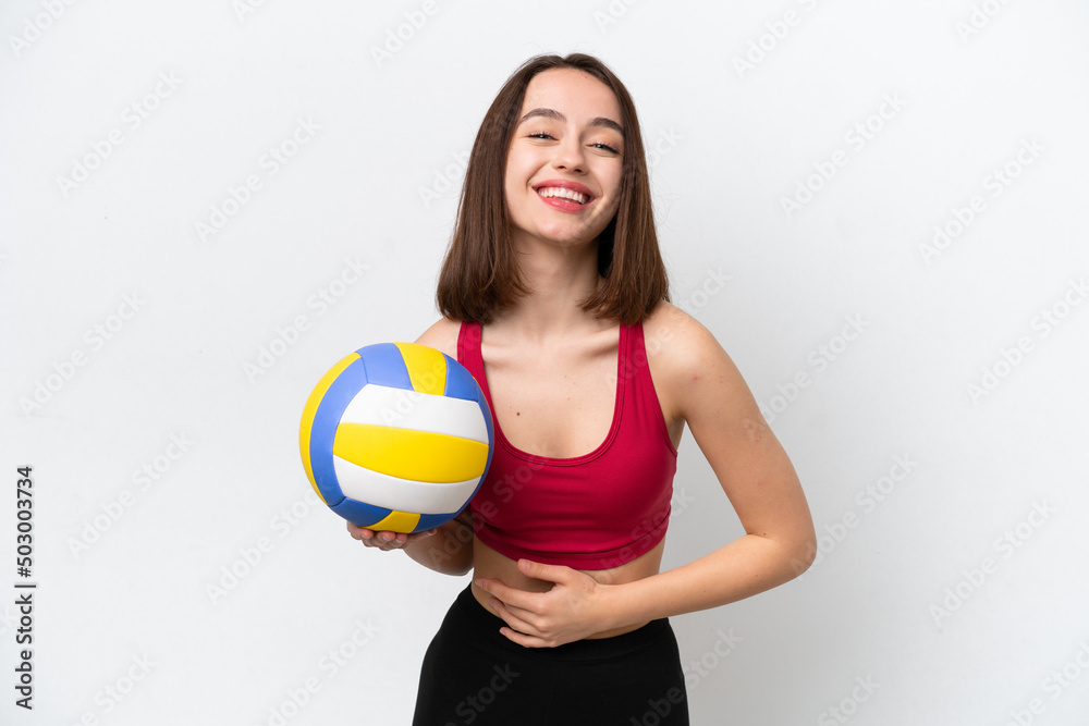 Young Ukrainian woman playing volleyball isolated on white background smiling a lot