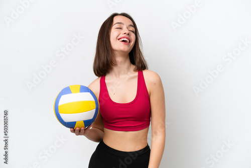 Young Ukrainian woman playing volleyball isolated on white background laughing