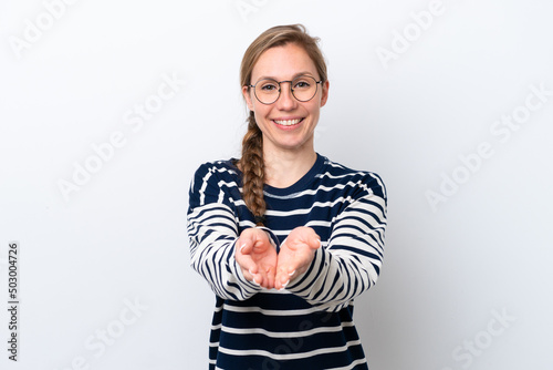 Young caucasian woman isolated on white background holding copyspace imaginary on the palm to insert an ad