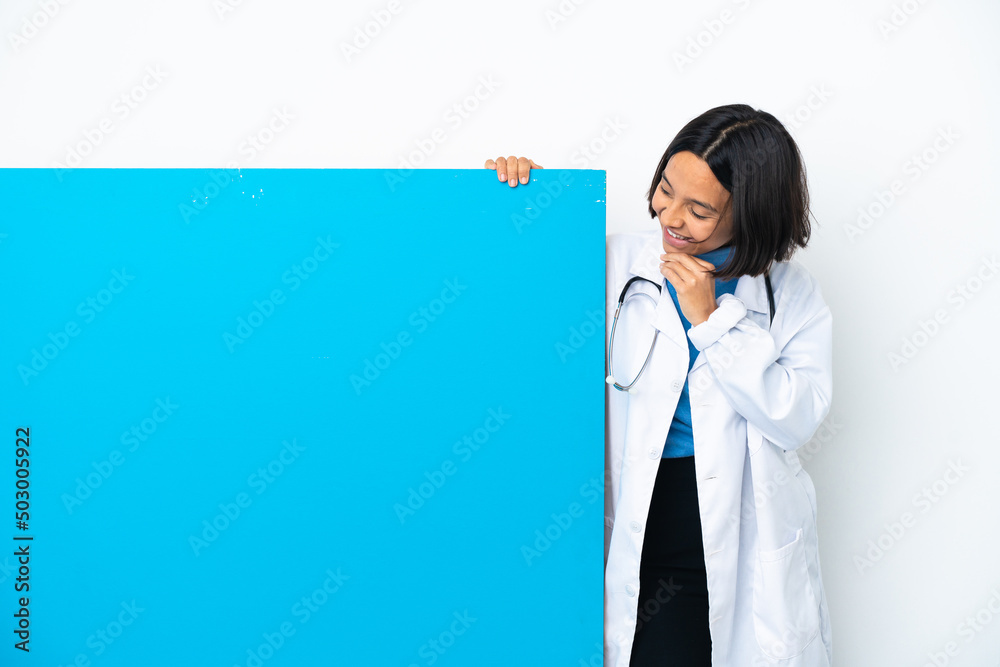Young mixed race doctor woman with a big placard isolated on white background looking up while smiling Young mixed race doctor woman with a big placard isolated on white background looking up while smiling