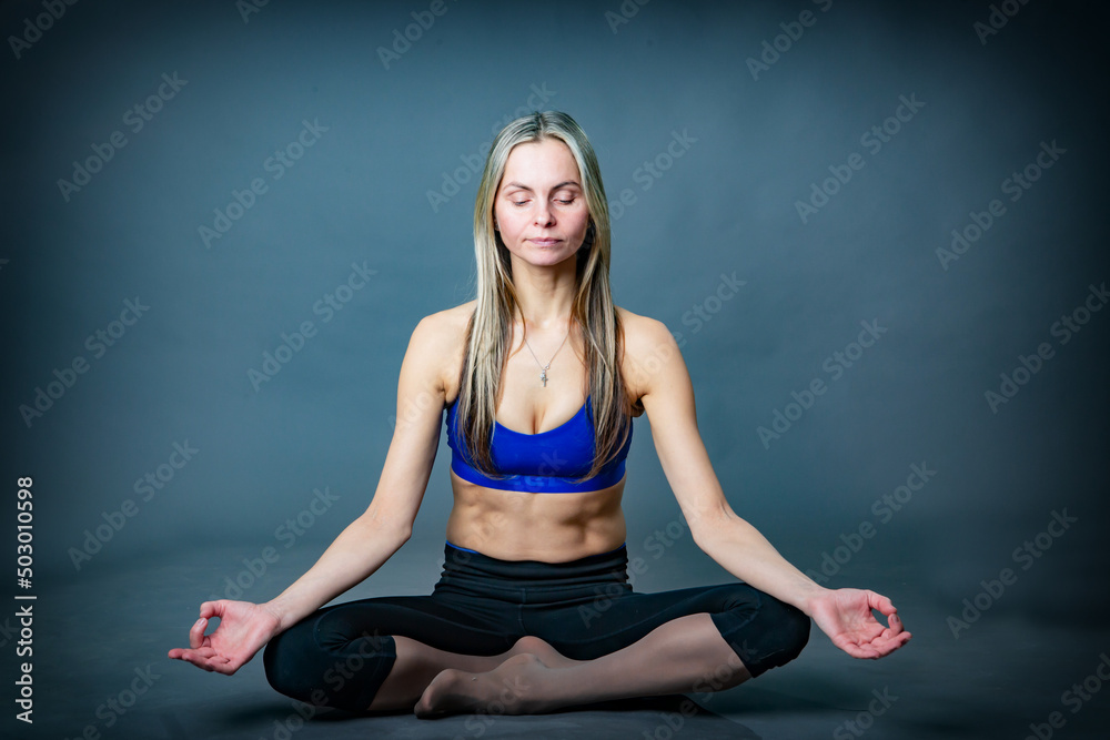 Fototapeta premium A woman is sitting in a yoga pose