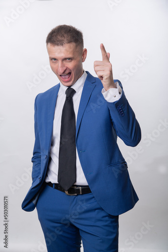 An adult man jokingly shoots with his fingers