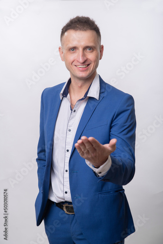 A young man in a blue suit asks