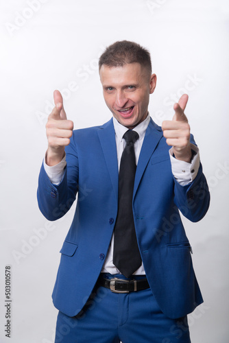 An adult man jokingly shoots with his fingers